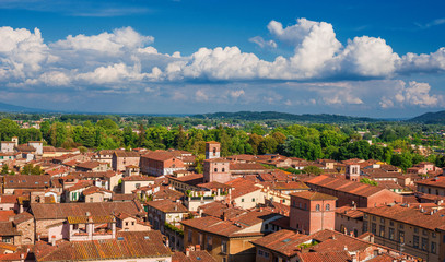 Fototapeta na wymiar Lucca old historic center skyline with medieval towers and clouds