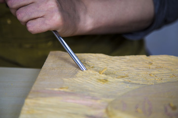 Sculptor Uses Tool To Sculpt Side Of Statue. Sculptor at work.