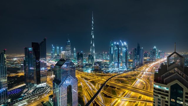 Night aerial panoramic Hyperlapse time lapse of Dubai over the Highway, traffic, Burj Khalifa in the background