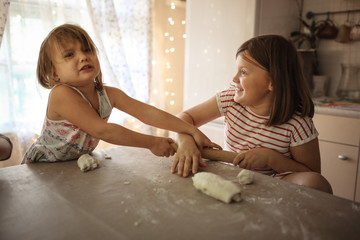 Children in real kitchen make dough and swear