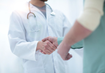 patient shakes hands with his physician