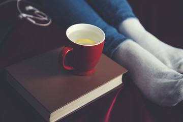 book and hot tea woman hand