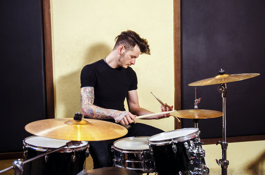 Tattooed drummer on rehearsal 