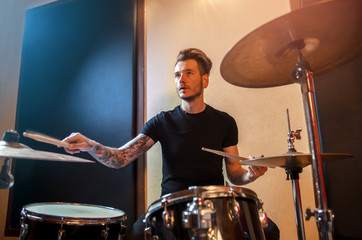 Fototapeta na wymiar Drummer playing drums in studio / concert 