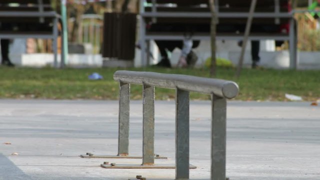 Skater make trick nollie lipslide on rail in skatepark, close-up view slowmotion