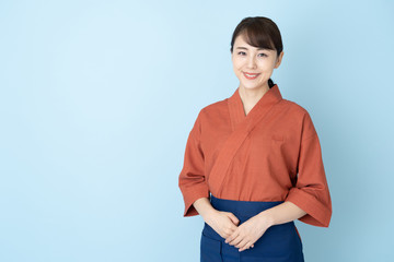 portrait of japanese style waitress isolated on blue background