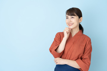 portrait of japanese style waitress isolated on blue background