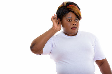 Studio shot of fat black African woman listening ready for gym