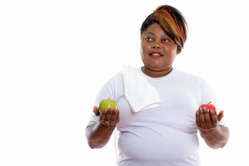 Studio shot of happy fat black African woman smiling and thinkin