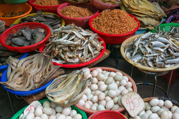 Farmers market stall selling eggs and cured seafood with dry fish