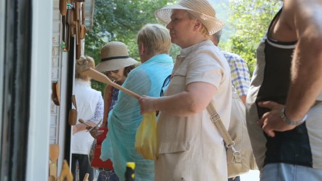 Group of tourists shopping in street shop