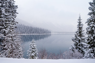 Snowing On Mountain Lake in Early Winter