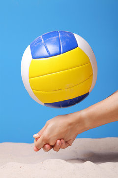 Hands of a beach volleyball female player digging a ball