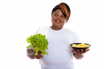 Studio shot of happy fat black African woman smiling and thinkin