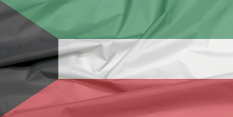 Fabric flag of Kuwait. Crease of Kuwaiti flag background, green white and red color with black...