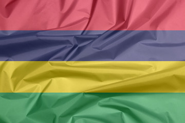 Fabric flag of Mauritius. Crease of Mauritian flag background, Four horizontal bands of red blue yellow and green.