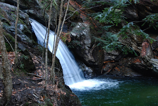 Waterfall in dense forest in autumn