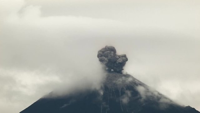 Reventador Volcano erupting in the early morning, November 2015. The mountain is situated in a remote part of the Ecuadorian Amazon surrounded by rainforest. Red hot boulders thrown out of the crater