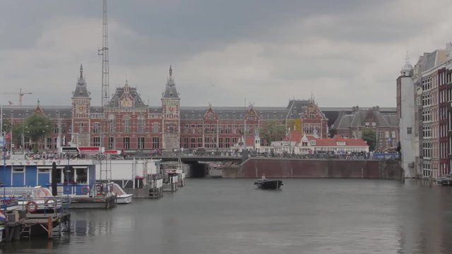 Amsterdam, The Netherlands - 20th August 2018: Boats, Canal and Houses near Amsterdam Central Station
