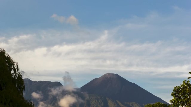 Reventador Volcano erupting, November 2015. The mountain is situated in a remote part of the Ecuadorian Amazon. The rainforest covered slopes in foreground are part of the caldera. Time-lapse.