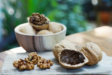 Group of walnut in wooden bowl on wood background, copy space, super food concept