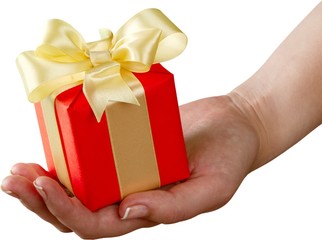 Human hand holding Little christmas box with bow isolated on