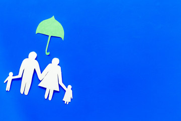 Illustration of social security concept. Financial protection. Family silhouette, cutout under umbrella on blue background top view copy space