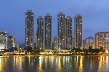 High rise residential building and river in Hong Kong city at dusk