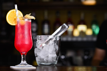 Strawberry Colada. Red cocktail on the bar. Decorated glass of coctail on the bar table.