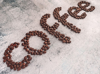 word made of coffee beans on cement background