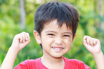 Asian boy raised his hands up