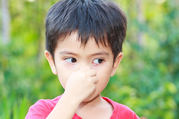 Asian boy pinch on nose