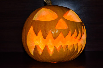 Fototapeta premium Spooky halloween pumpkin on a black background