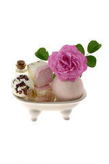 bath bombs with rose extract in a decorative bath on a white background.Body cosmetics with rose extract 