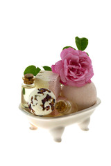bath bombs with rose extract in a  bath on a white background.Body cosmetics with rose extract 
