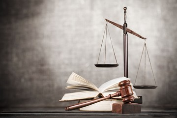 Law scales on table background. Symbol of