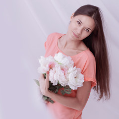 lovely young woman with a bouquet of peonies.photo with copy space