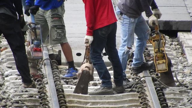 construction workers at repair railroad tracks