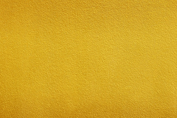 Gold paint on rough cement wall texture background