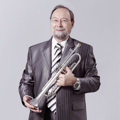man in a gray suit with a trumpet © yurolaitsalbert