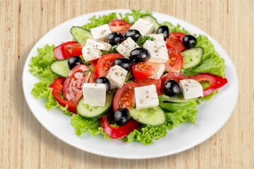 Greek salad with fresh vegetables on background