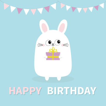 Happy Birthday. White bunny rabbit holding gift box. Paper flags hanging. Funny head face. Big eyes. Cute kawaii cartoon character. Baby greeting card template. Blue background. Flat design.