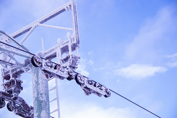 Ski resort snow-covered ski lift and clear blue sky in the background