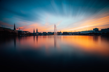 Panoramic view of Binnenalster, Inner Alster Lake in golden and blue evening light at sunset, Hamburg, Germany. Blue hour. Long exposure - obrazy, fototapety, plakaty