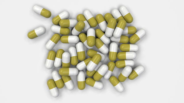 Pile of white and yellow medicine capsules