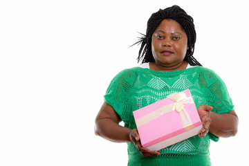 Studio shot of fat black African woman holding gift box