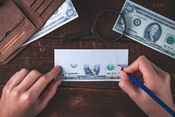 Counterfeiter forges banknotes. Fake concept. Fake money, a wallet with American dollars, a...