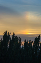 Landscape with dramatic light - beautiful golden sunset with saturated sky and clouds.