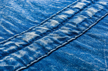Blue washed faded jeans texture with seams