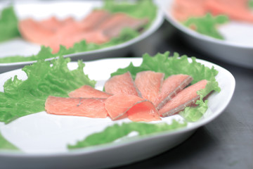 dishes with red fish on the table in the kitchen of the restaurant